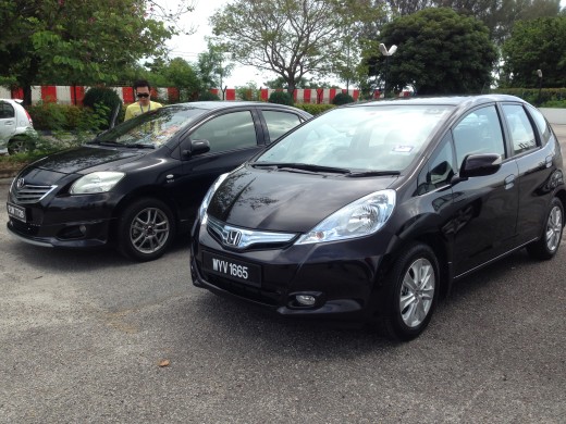 Honda Jazz Hybrid is beside Toyota Vios