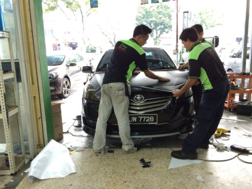 the staffs are warping the carbon fiber vinyl on Toyota Vios