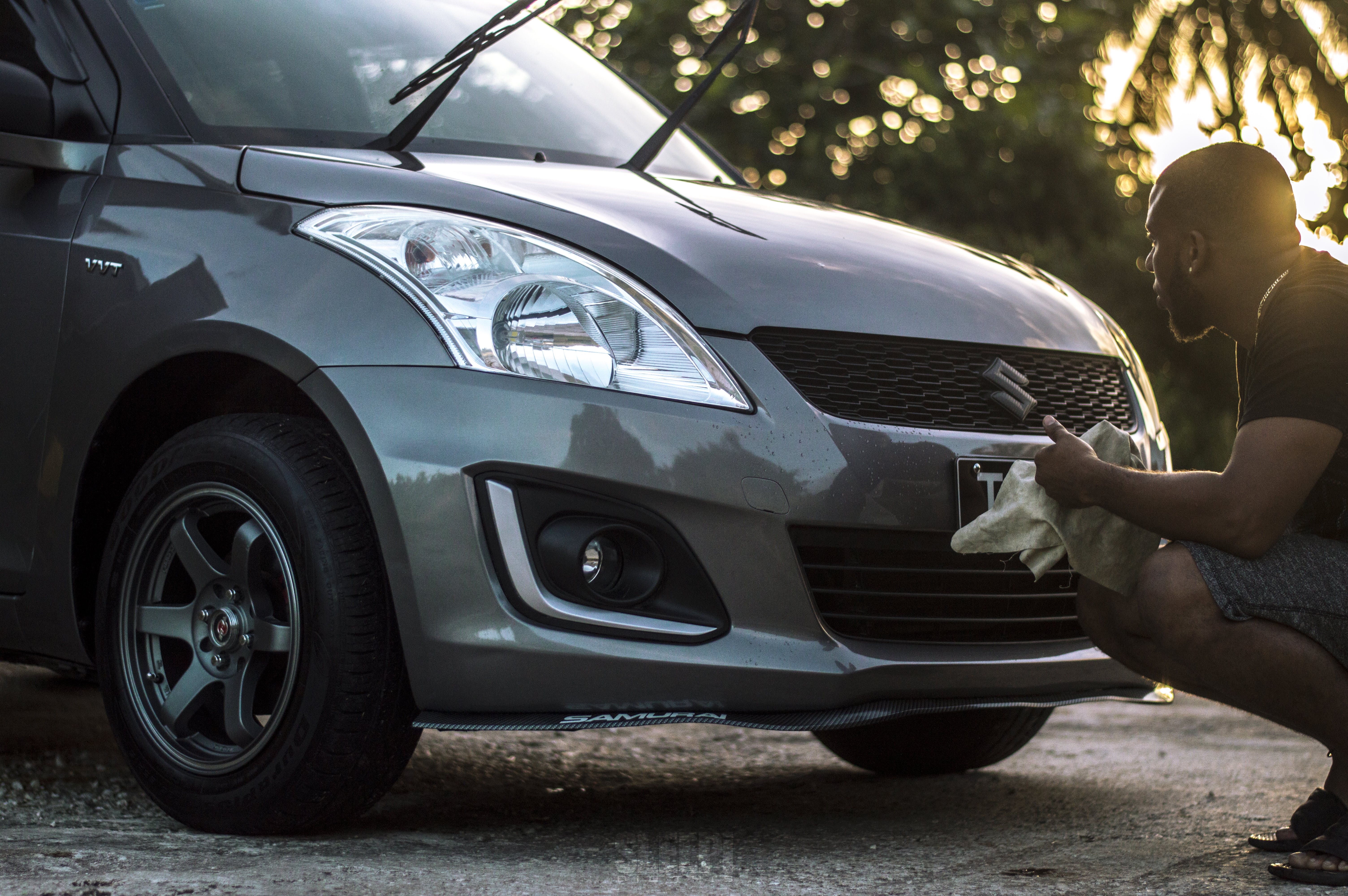 Photo of Man Cleaning His Car